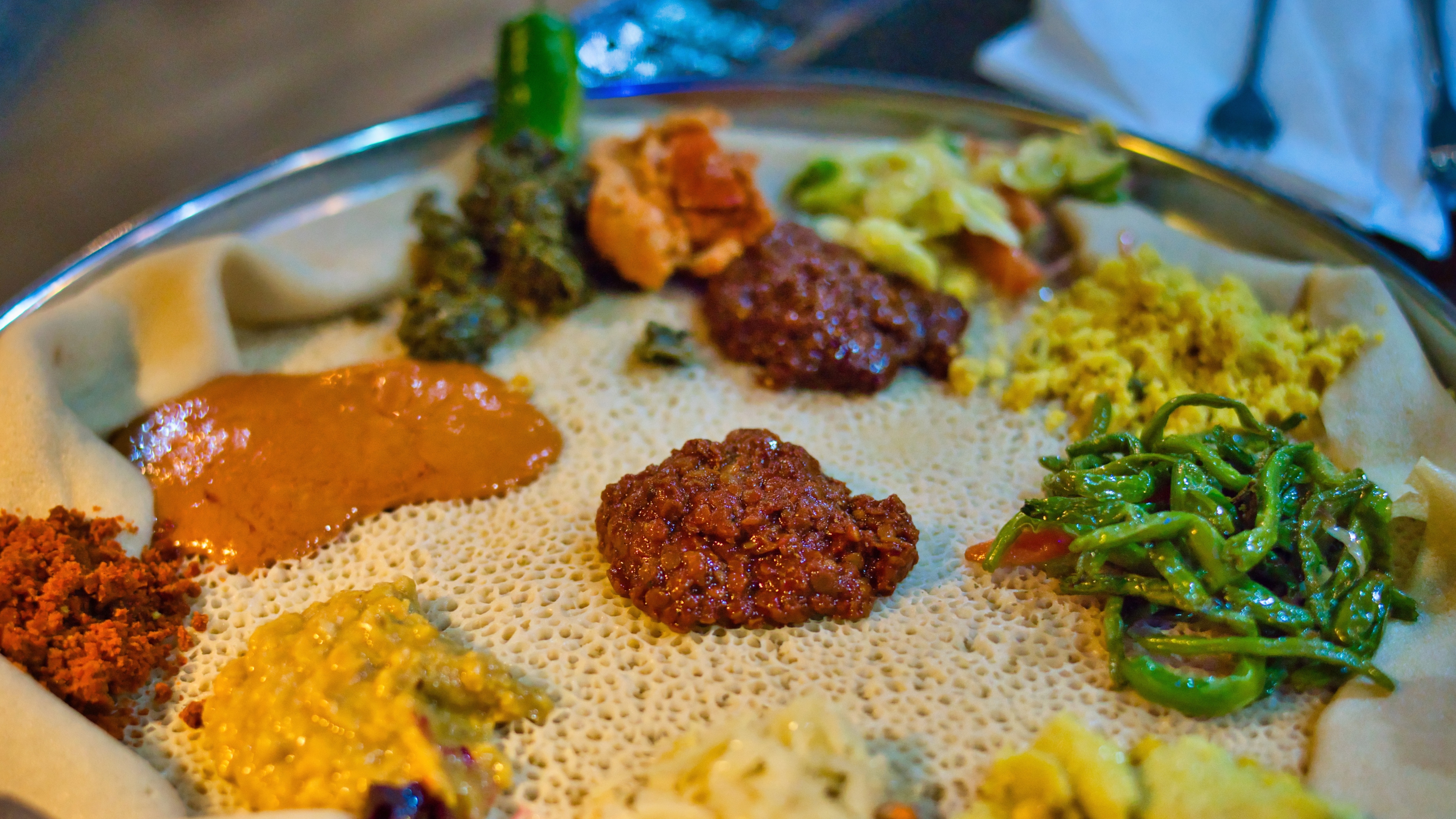 Addis Ababa, Ethiopia - December 18, 2018: Beyaynetu food, which is an Ethiopian combination platter, served on injera, which represents the traditional Ethiopian flat bread.