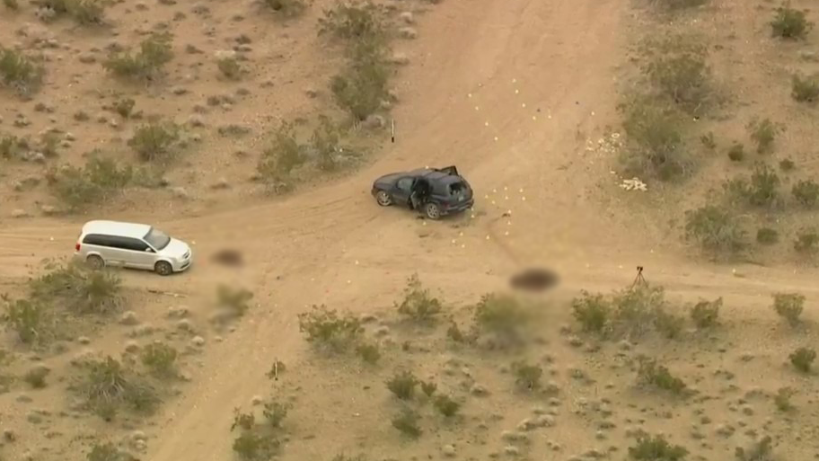 This aerial image from Sky5 taken on Jan. 24, 2024, shows two vehicles where several people were found shot to death in El Mirage. (KTLA)