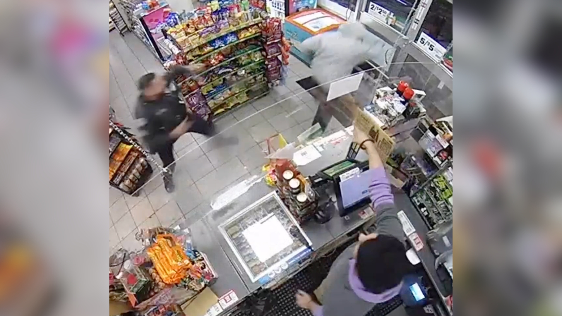 Police officer walks in 7-Eleven as armed robbery in progress