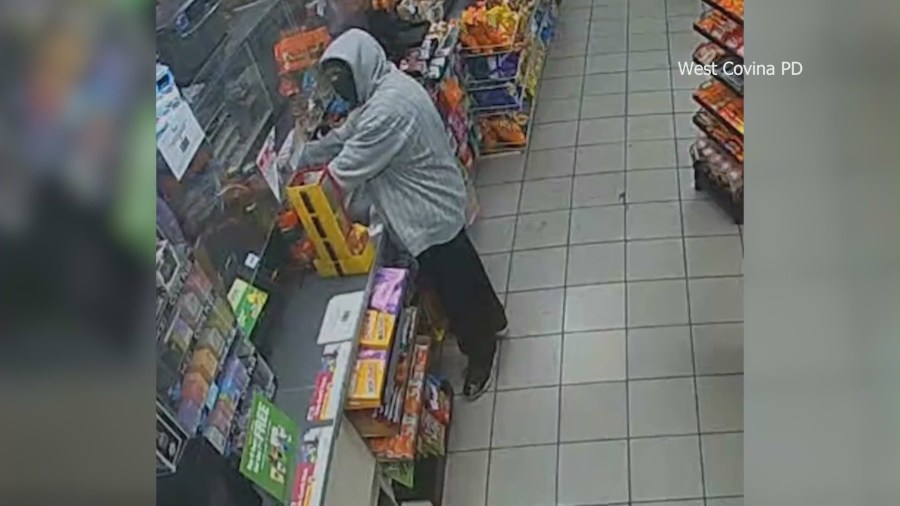 Cameras capture the moment a police officer coincidentally walks into a 7-Eleven during an armed robbery in West Covina on Jan. 17, 2024. (West Covina Police Department)