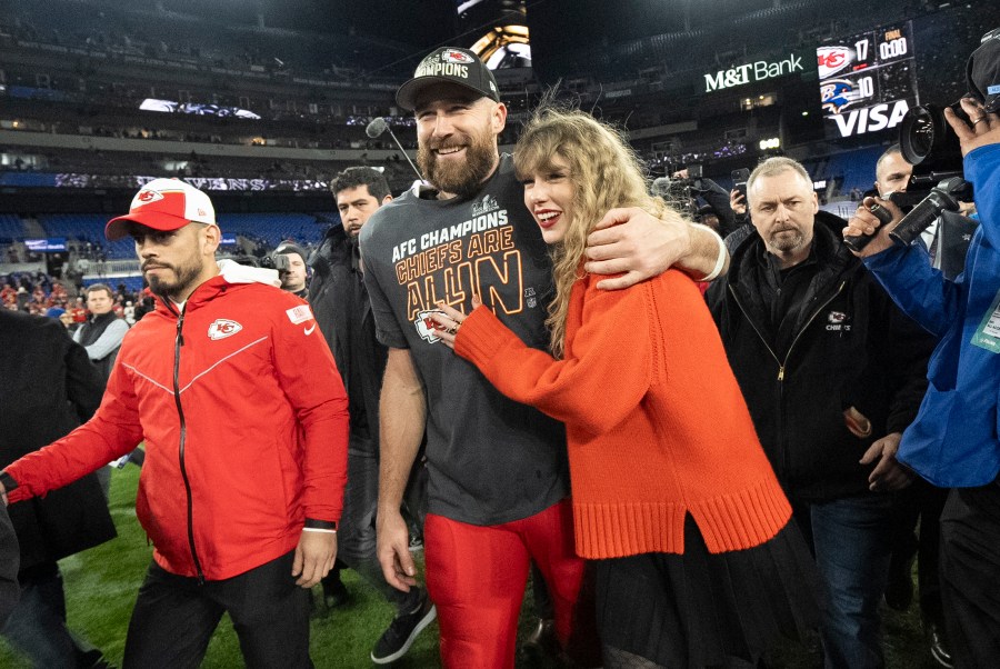 FILE - Kansas City Chiefs tight end Travis Kelce and Taylor Swift walk together after an AFC Championship NFL football game between the Chiefs and the Baltimore Ravens, Jan. 28, 2024, in Baltimore. For weeks, scrutiny over Swift’s travel has been bubbling up on social media, with people pointing out the planet-warming emissions of carbon dioxide released with every flight. (AP Photo/Julio Cortez, File)