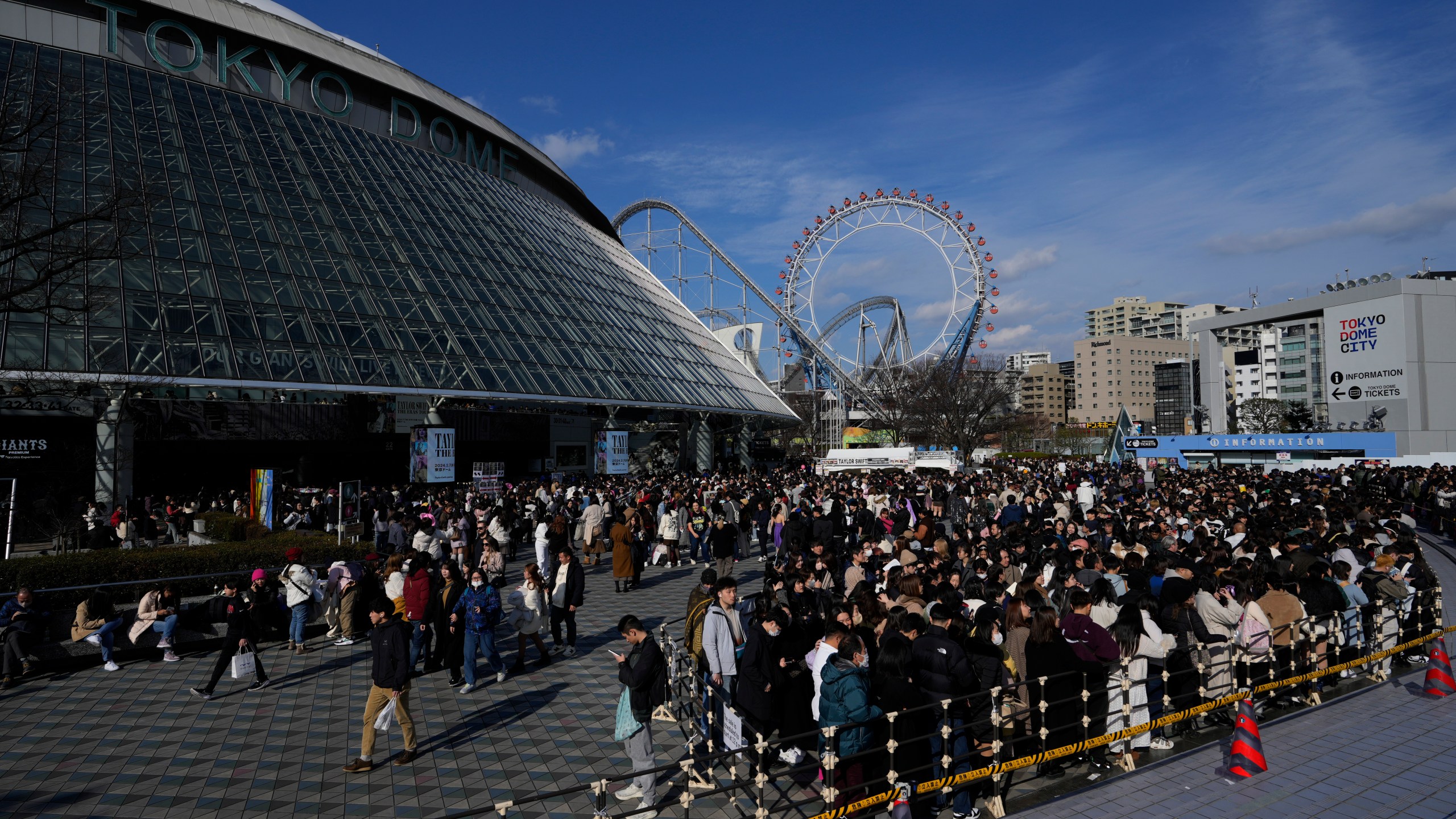 People gather around Tokyo Dome before Taylor Swift's concert in Tokyo, Saturday, Feb. 10, 2024. (AP Photo/Hiro Komae)