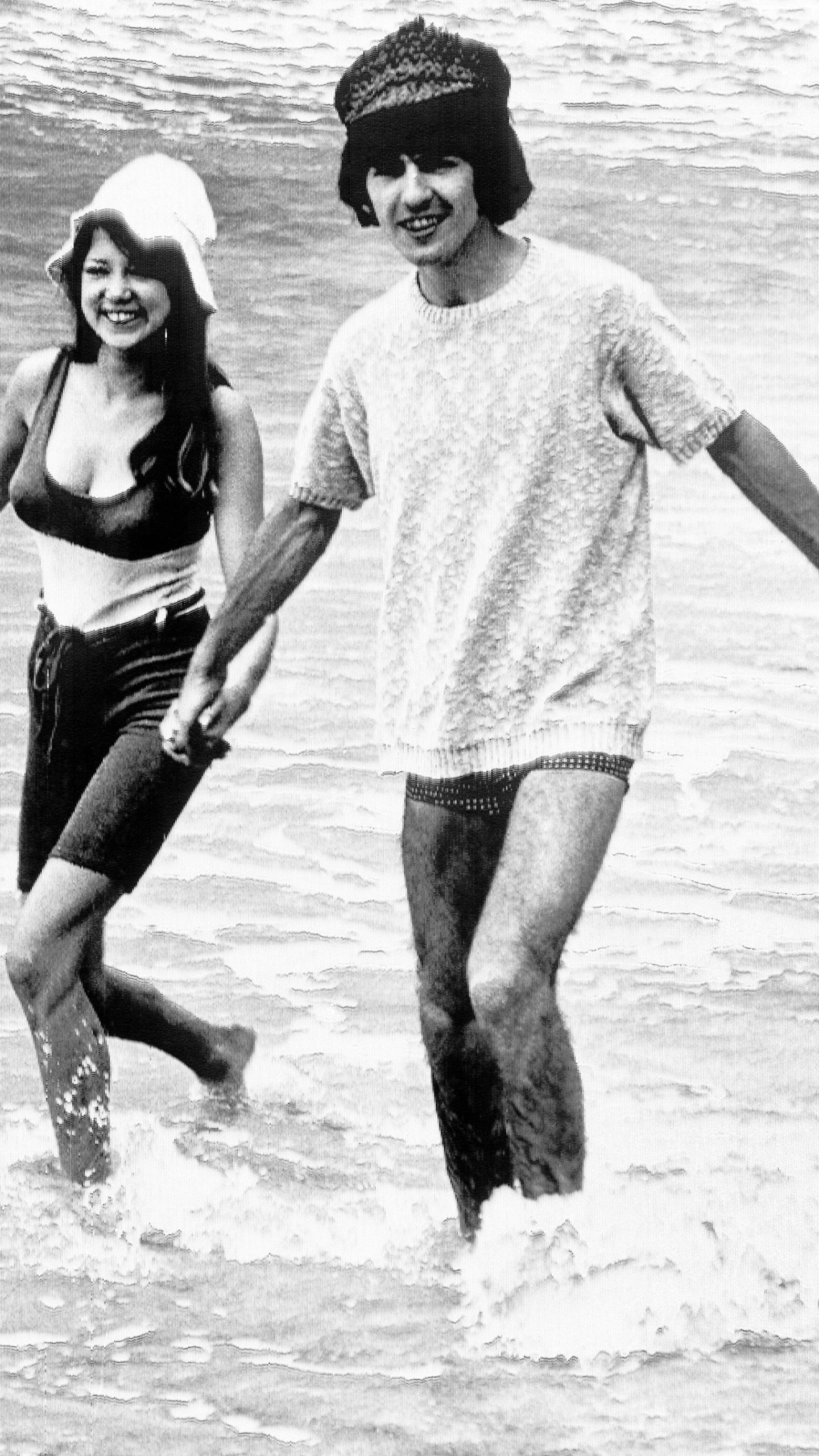 George Harrison, of the Beatles singing group, splashes in the surf with his bride, former model Pattie Boyd, February 12, 1966. Love letters to Pattie Boyd from both George Harrison and Eric Clapton are going up for sale at Christie’s auction house, alongside clothing, jewelry and other memorabilia from the renowned model and musicians’ muse. (AP Photo, File)