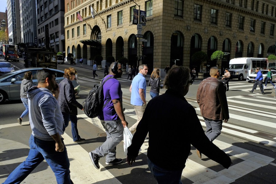 People using a crosswalk in a high-traffic street in downtown Los Angeles. (AP)