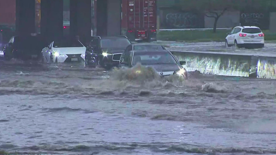 Cars pass through a flooded 710 Freeway in Long Beach on Feb. 1, 2024.