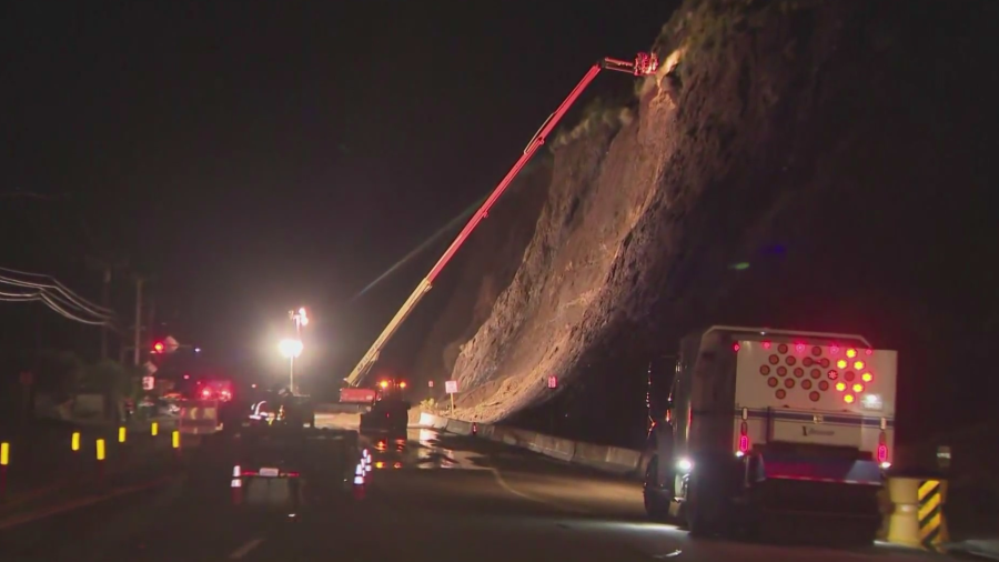 Crews used a cherry picker and hand tools to break rock and mud away from the cliff.