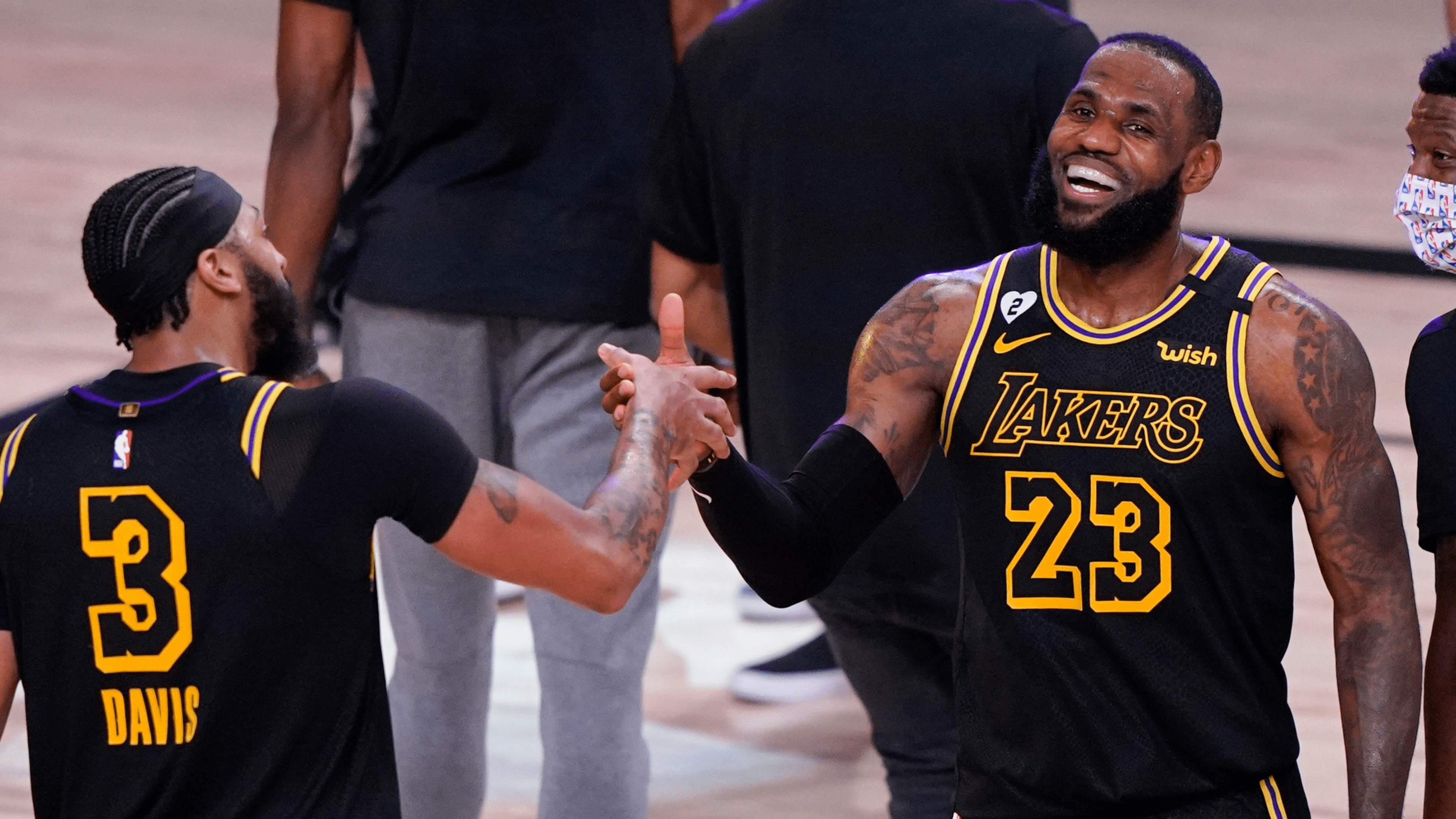 In this Sunday, Sept. 20, 2020, file photo, Los Angeles Lakers' LeBron James celebrates with teammate Anthony Davis after an NBA conference final playoff basketball game against the Denver Nuggets in Fla.