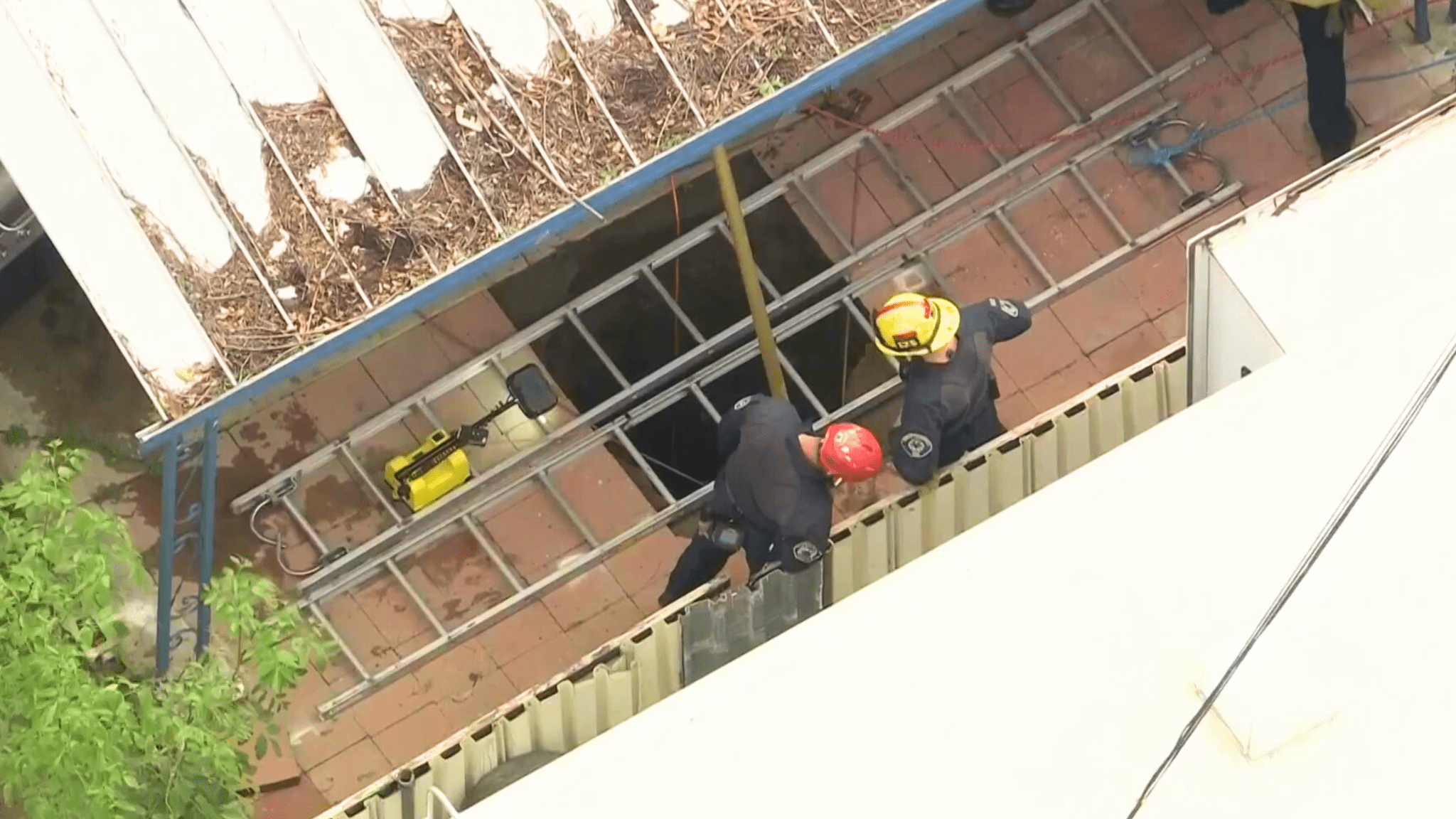 Crews work to rescue a woman from a sinkhole in Fontana on Feb. 8, 2024.