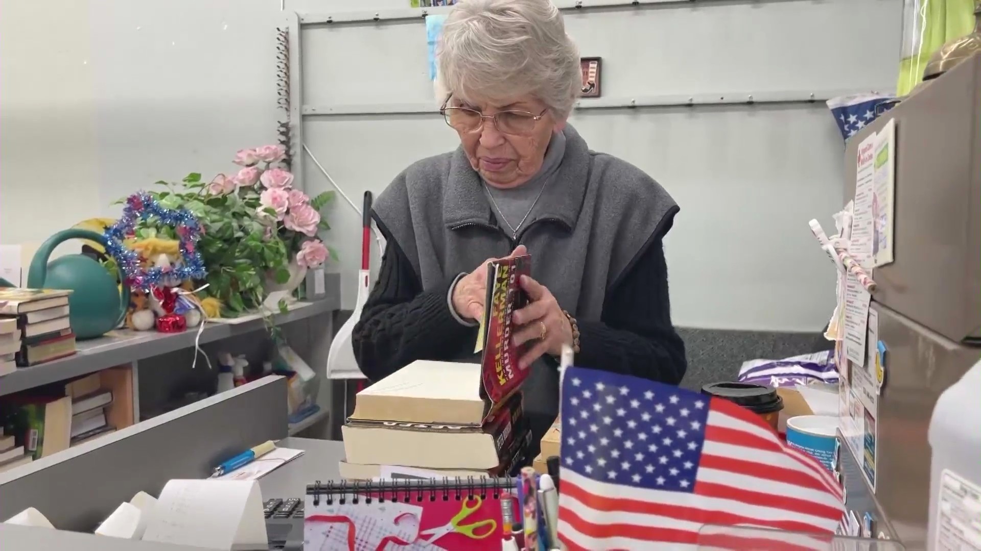 Karen Kropp sells books to a loyal customer at The Book Rack before closing up shop after over 40 years of operation on Feb. 27, 2024. (KTLA)