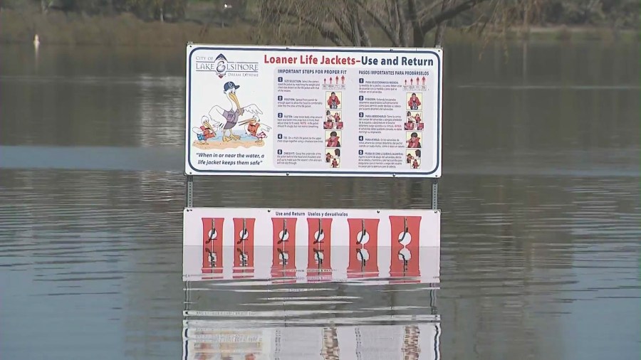 A sign is submerged in Lake Elsinore due to surging water levels from a series of record-setting rainstorms. (KTLA)