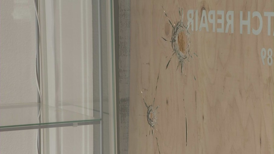 Bullet holes in the window of Geneva Jewelry after a smash-and-grab robbery. (KTLA)