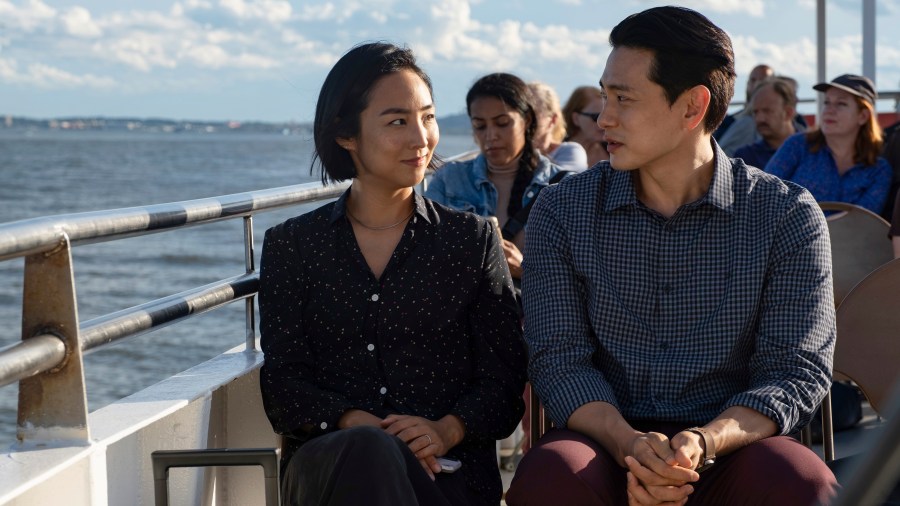 This image released by A24 shows Greta Lee, left, and Teo Yoo in a scene from "Past Lives." (Jon Pack/A24 via AP)