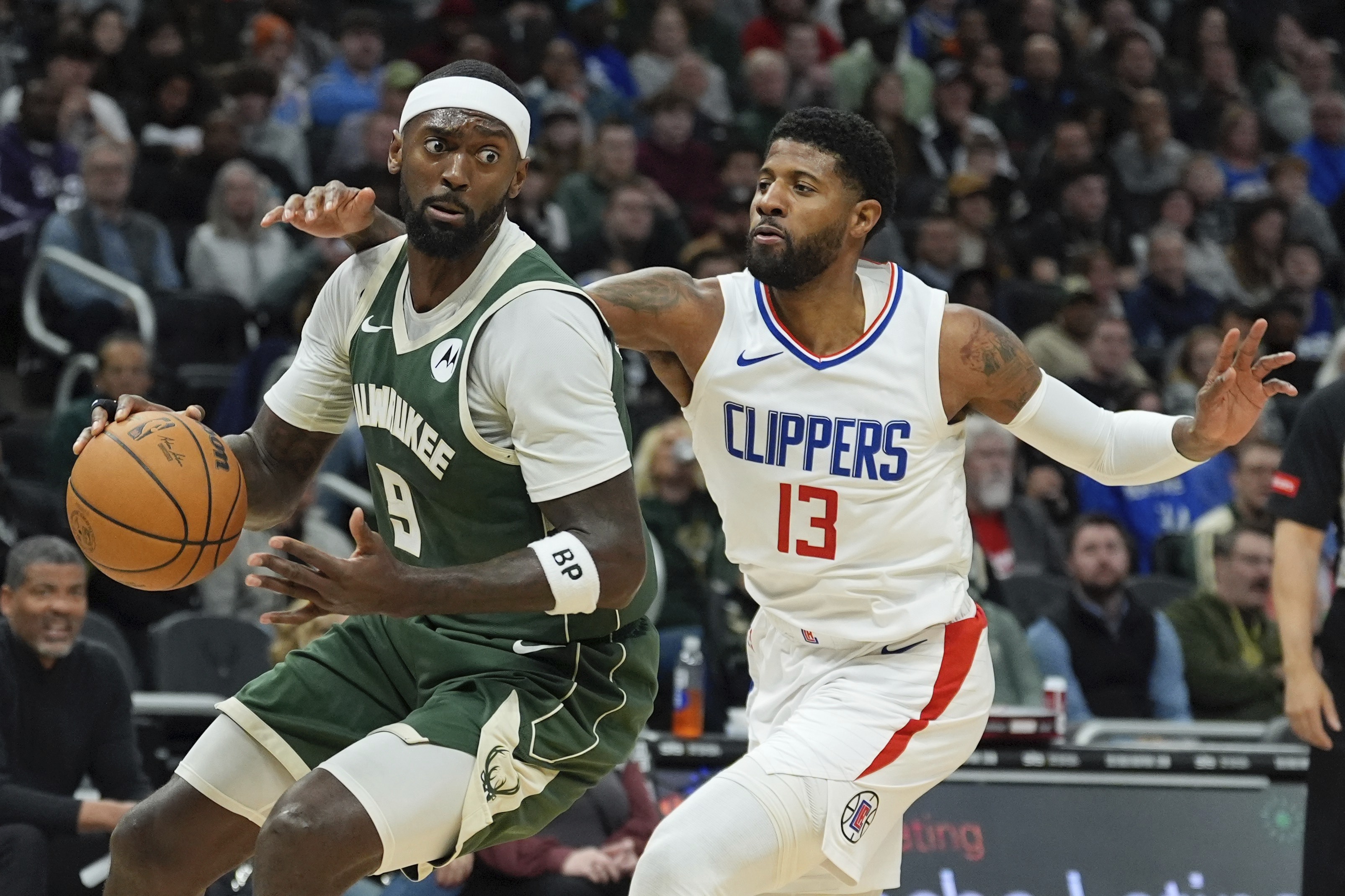 Milwaukee Bucks' Bobby Portis looks to get past LA Clippers' Paul George during the first half of an NBA basketball game Monday, March 4, 2024, in Milwaukee. (AP Photo/Morry Gash)