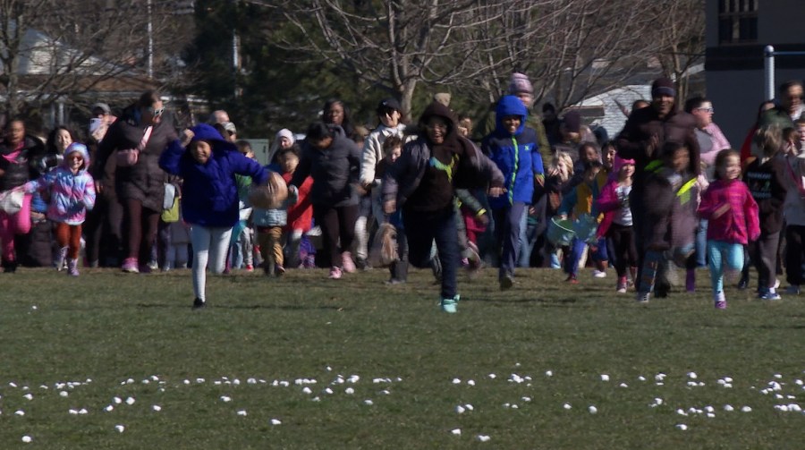 In this photo made from video, a child points to the sky, where a helicopter had dropped thousands of marshmallows to a park below in Southfield, Mich., on Friday, March 29, 2024. The annual Great Marshmallow Drop took place at Catalpa Oaks County Park in Southfield, Michigan, and was hosted by Oakland County Parks. (AP Photo/Mike Householder)