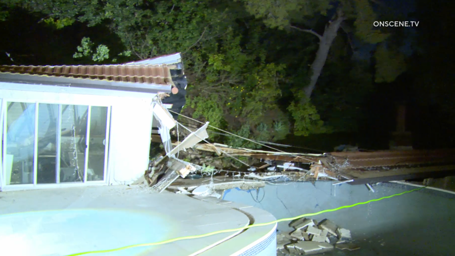 A landslide tore through the backyard of a home in Sherman Oaks on March 13, 2024.