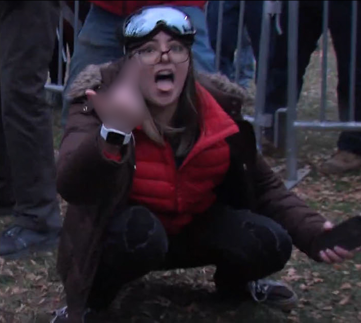 A photo shared by the FBI allegedly shows Kayla Reifschneider holding up her middle finger after stomping a camera at the Jan. 6, 2021 riot at the U.S. Capitol