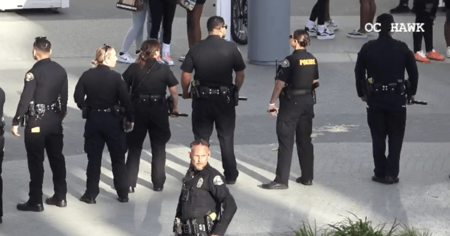 Long Beach Police officers patrol the area after breaking up a fight between two juveniles at the Long Beach Pike Outlets on March 16, 2024. (OC Hawk)