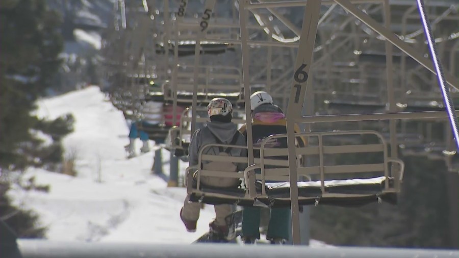 Skiers and snowboarders riding chair lifts at Mountain High Resort in Wrightwood, California. (KTLA)