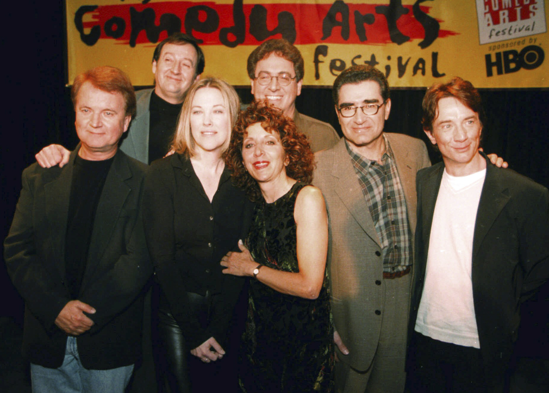 FILE - Former cast members of SCTV, from left, Dave Thomas, Joe Flaherty, Catherine O'Hara, Andrea Martin, foreground, Harold Ramis, Eugene Levy and Martin Short, pose at the U.S. Comedy Arts Festival on March 6, 1999, in Aspen, Colo. Flaherty, a founding member of the Canadian sketch series “SCTV,” died Monday, April 1, 2024 at age 82. (AP Photo/E Pablo Kosmicki, File)