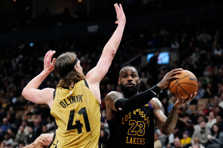 Los Angeles Lakers forward LeBron James (23) tries to get past Toronto Raptors forward Kelly Olynyk (41) during the second half of an NBA basketball game Tuesday, April 2, 2024, in Toronto. (Frank Gunn/The Canadian Press via AP)