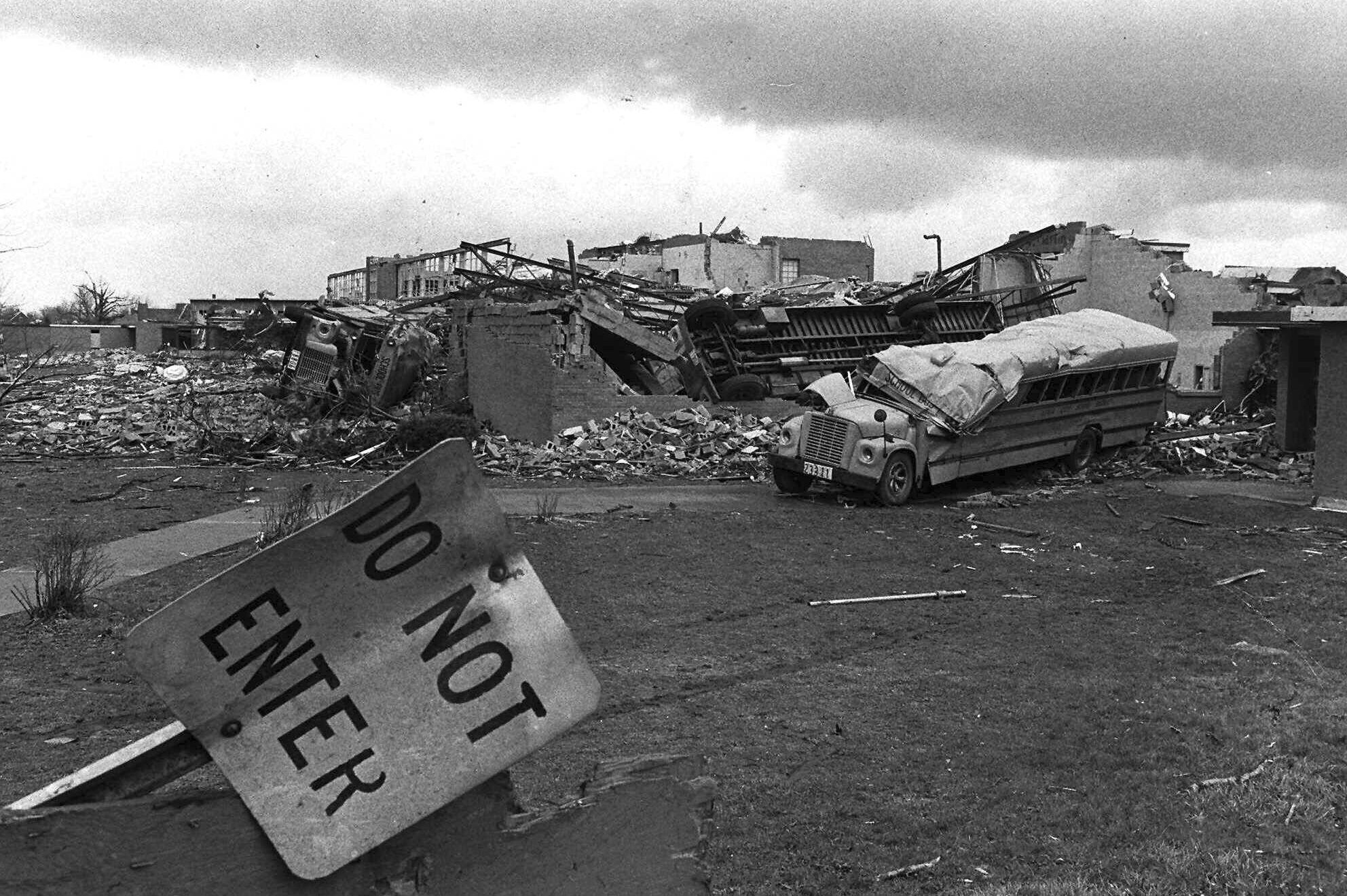 FILE - School buses rest April 5, 1974, on the remains of the high school where they were tossed in Xenia, Ohio, by a tornado that went through the town. The deadly tornado killed 32 people, injured hundreds and leveled half the city of 25,000. Nearby Wilberforce was also hit hard. As the Watergate scandal unfolded in Washington, President Richard Nixon made an unannounced visit to Xenia to tour the damage. Xenia's was the deadliest and most powerful tornado of the 1974 Super Outbreak. (AP Photo, file)