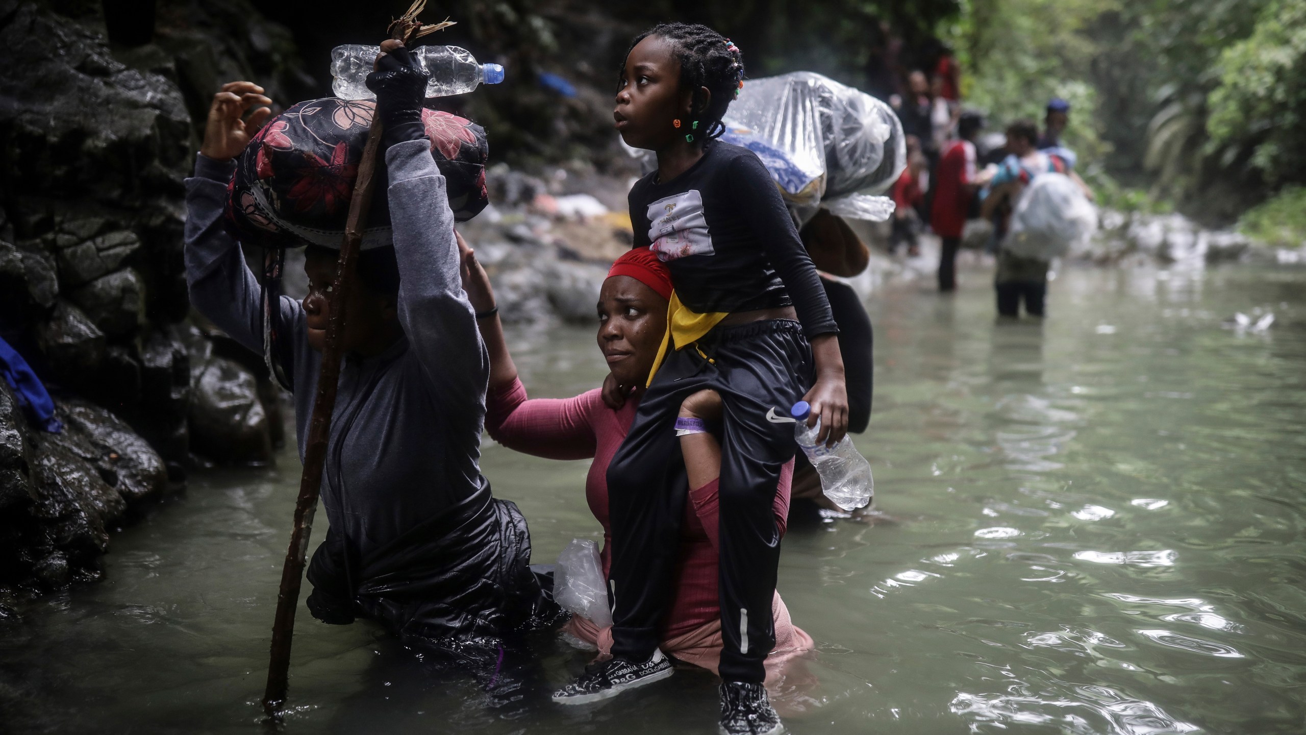 FILE - Haitian migrants wade through water as they cross the Darien Gap from Colombia to Panama in hopes of reaching the United States, May 9, 2023. Colombia and Panama are failing to protect hundreds of thousands of migrants who are crossing the Darien jungle on their way to the U.S. and have become increasingly vulnerable to robberies and sexual violence, Human Rights Watch said in a report published Wednesday, April 3, 2024. (AP Photo/Ivan Valencia, File)