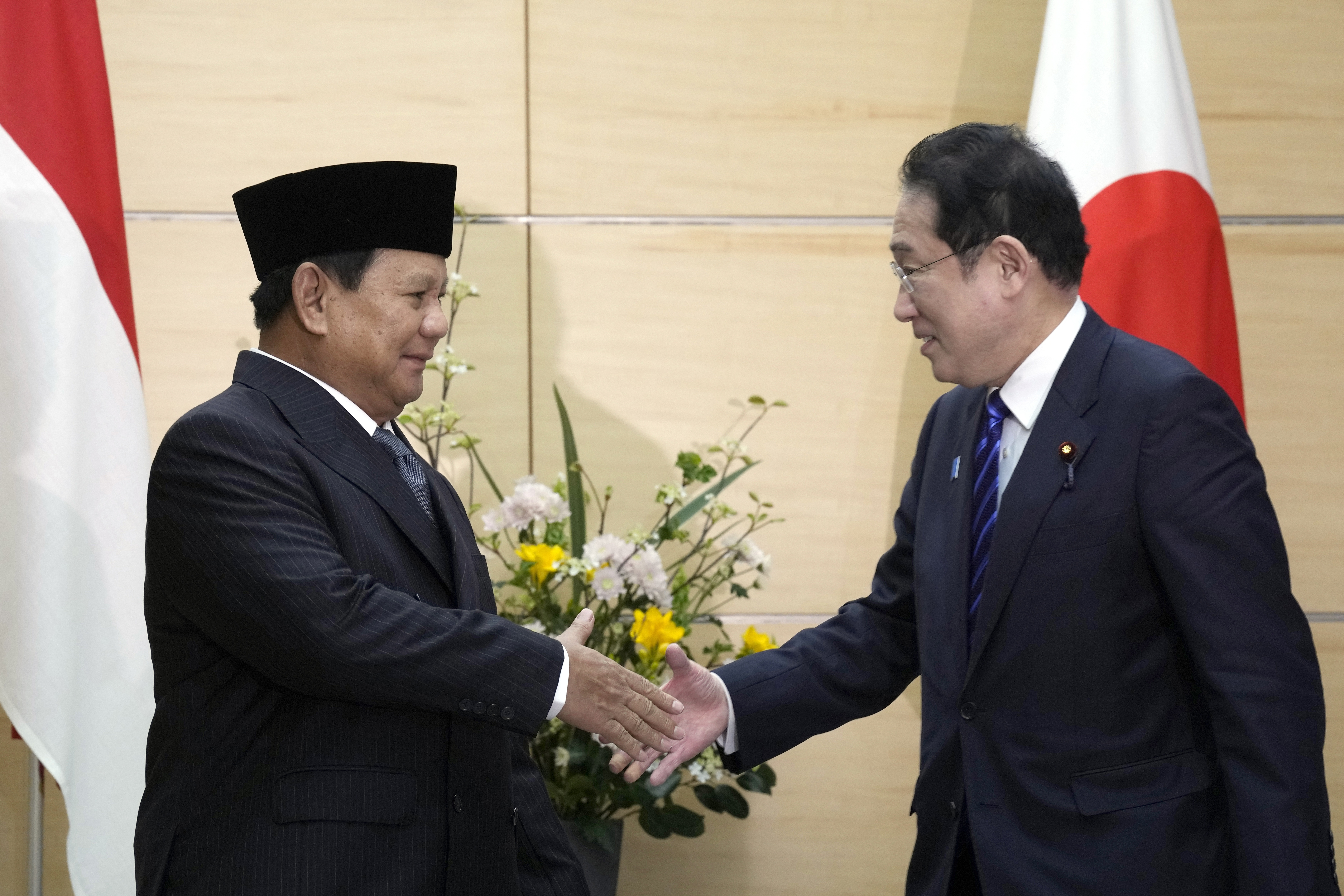 Indonesian President-elect and current Defense Minister Prabowo Subianto, left, and Japan's Prime Minister Fumio Kishida, right, shake hands at the prime minister's office Wednesday, April 3, 2024, in Tokyo. (AP Photo/Eugene Hoshiko, Pool)