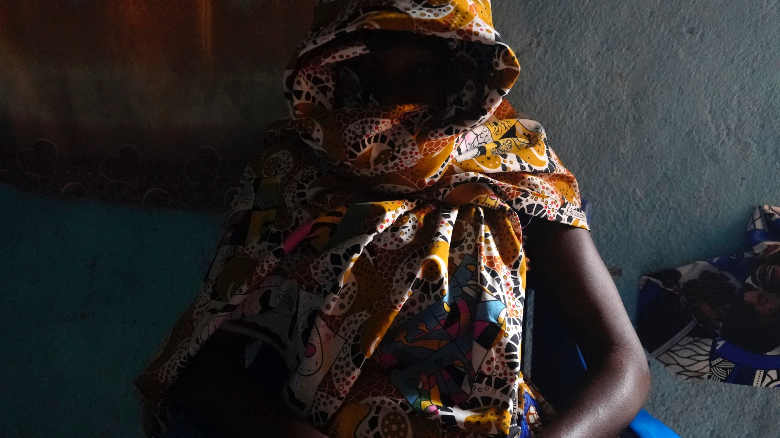 Carole, a 32-year-old former combatant, sits in her home in Bouar, Central African Republic, Thursday, March 7, 2024. Nearly 5,000 fighters have put down their arms in Central African Republic since a disarmament program launched nearly a decade ago. Yet former rebels, communities and conflict experts say it's hard to halt fighting in a country still in conflict and where little other paid work exists. (AP Photo/Sam Mednick)