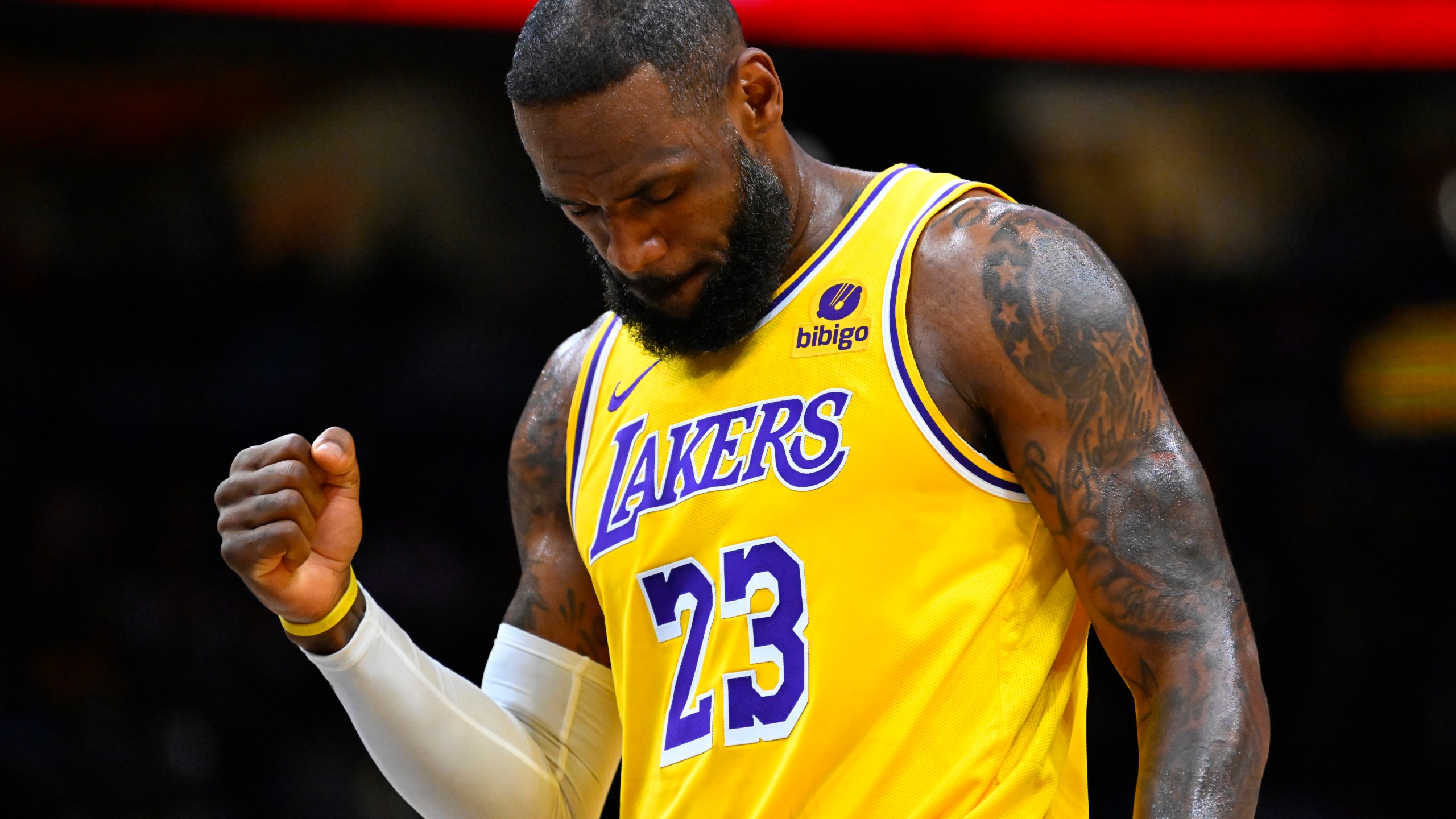 Los Angeles Lakers forward LeBron James clenches his fist after scoring against the Washington Wizards during the first half of an NBA basketball game Wednesday, April 3, 2024, in Washington. (AP Photo/John McDonnell)