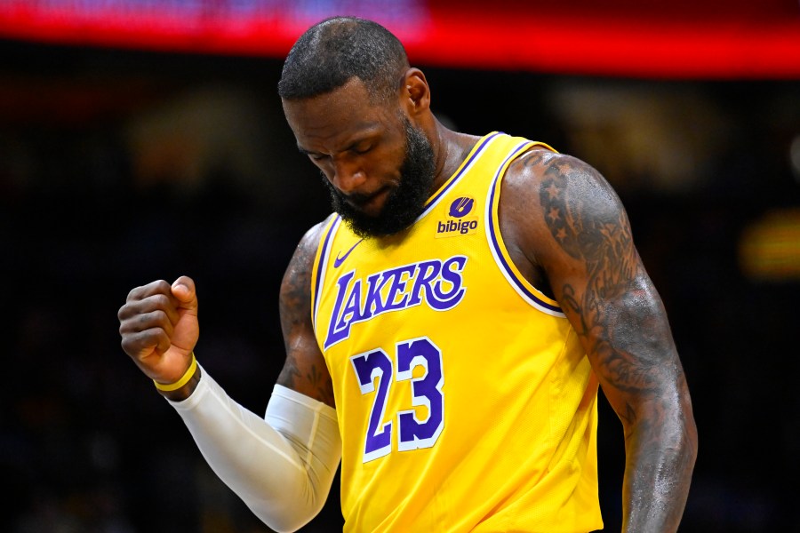 Los Angeles Lakers forward LeBron James clenches his fist after scoring against the Washington Wizards during the first half of an NBA basketball game Wednesday, April 3, 2024, in Washington. (AP Photo/John McDonnell)