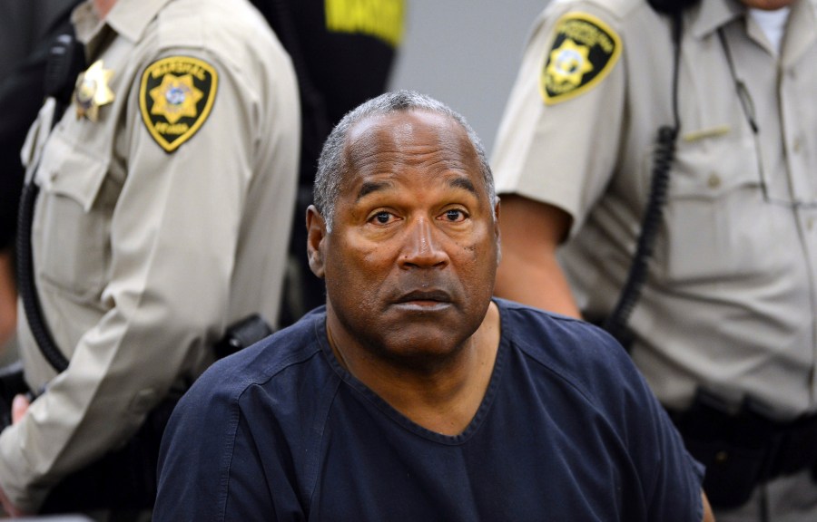 FILE - In this May 14, 2013, file photo, O.J. Simpson sits during a break on the second day of an evidentiary hearing in Clark County District Court in Las Vegas. Simpson, the decorated football superstar and Hollywood actor who was acquitted of charges he killed his former wife and her friend but later found liable in a separate civil trial, has died. He was 76. (AP Photo/Ethan Miller, Pool, File)