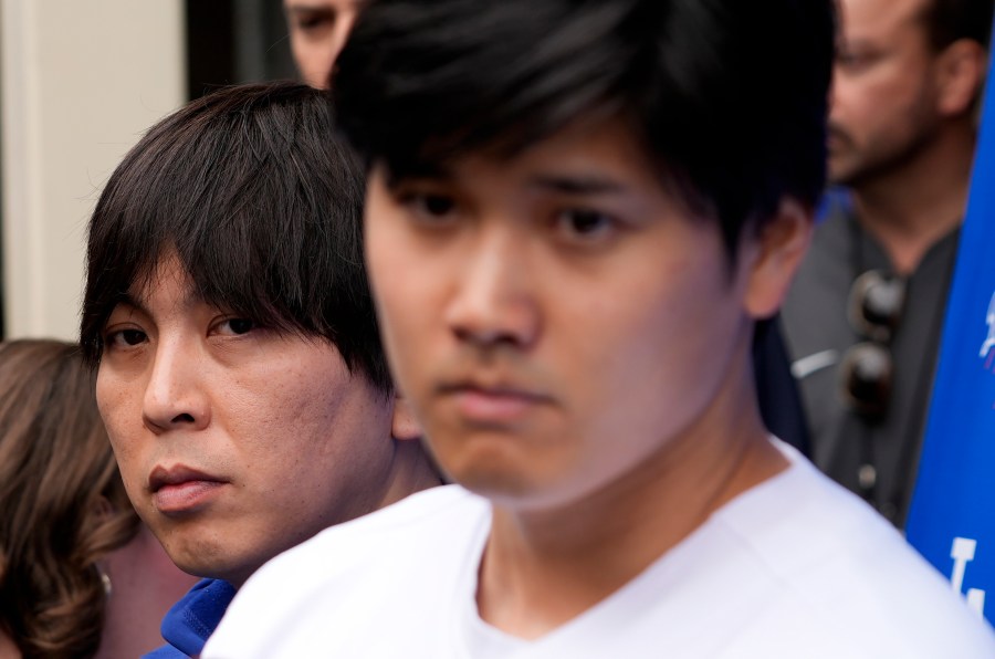 FILE - Ippei Mizuhara stands next to Japanese baseball star Shohei Ohtani and translates during an interview at Dodger Stadium on Feb. 3, 2024. The former longtime interpreter for Los Angeles Dodgers star Shohei Ohtani has been charged with federal bank fraud for crimes involving gambling debts and theft of millions of dollars from the slugger. Federal authorities announced the development Thursday, April 11, at a press conference in Los Angeles. (AP Photo/Richard Vogel, File)