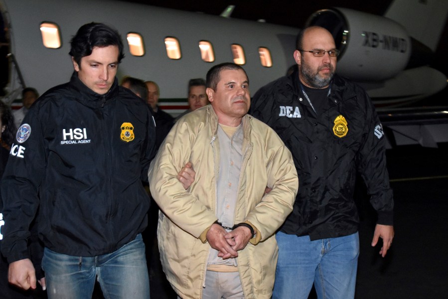 FILE - Authorities escort Joaquin "El Chapo" Guzman from a plane to a waiting caravan of SUVs at Long Island MacArthur Airport, in Ronkonkoma, N.Y., Jan. 19, 2017. Guzmán wrote a letter to District Court Judge Brian M. Cogan in the Eastern District of New York in late March 2024, claiming he cannot get phone calls or visits in the maximum security U.S. prison where he is serving a life sentence. (U.S. law enforcement via AP, File)