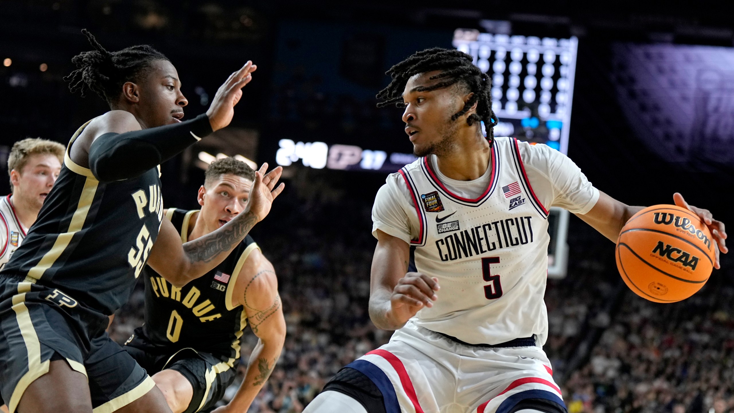 UConn guard Stephon Castle (5) drives as Purdue guard Lance Jones defends during the first half of the NCAA college Final Four championship basketball game, Monday, April 8, 2024, in Glendale, Ariz. (AP Photo/Brynn Anderson)