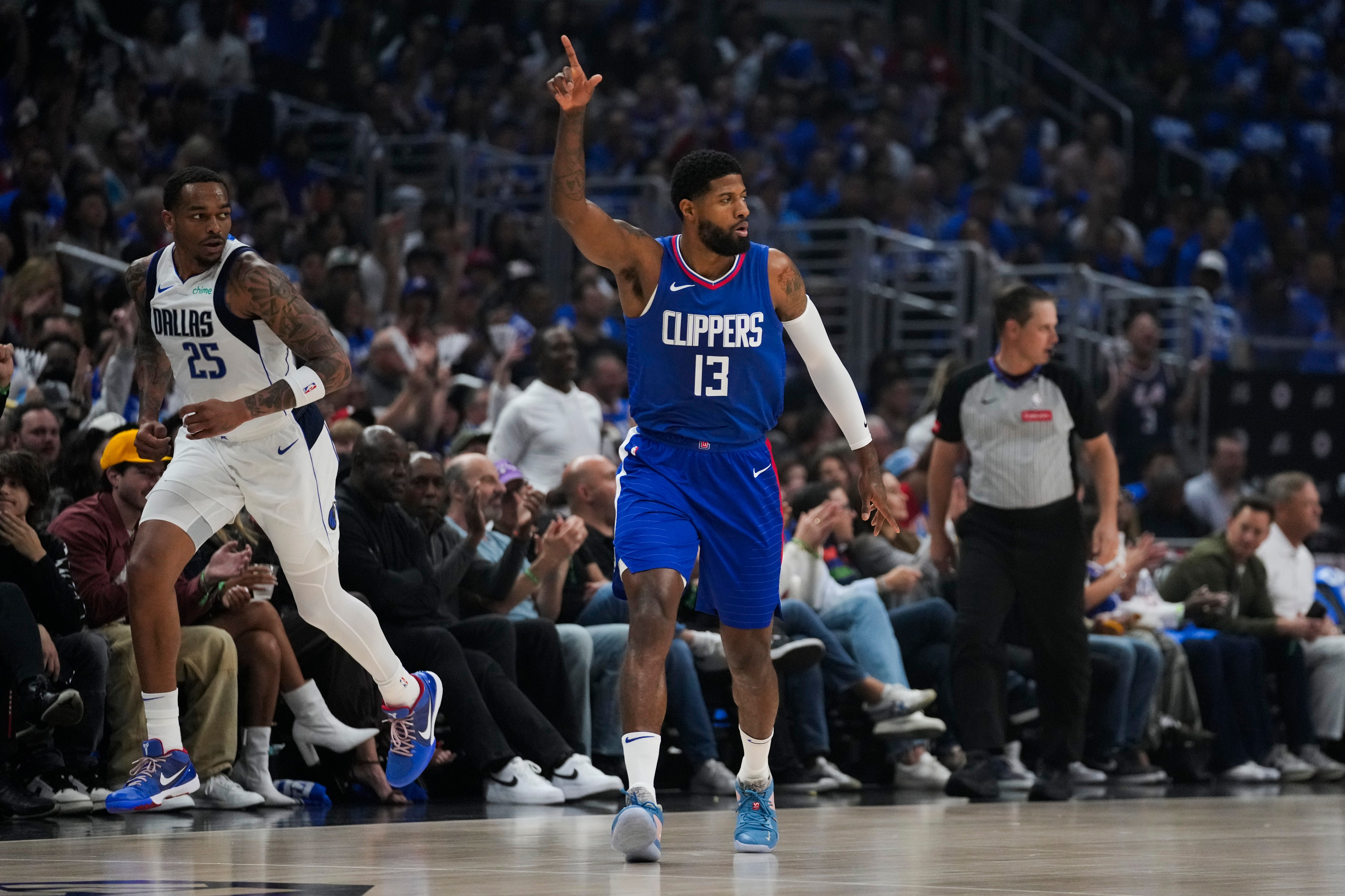 LA Clippers forward Paul George (13) celebrates after making a 3-pointer during the first half of Game 1 of an NBA basketball first-round playoff series against the Dallas Mavericks in Los Angeles, Sunday, April 21, 2024. (AP Photo/Ashley Landis)