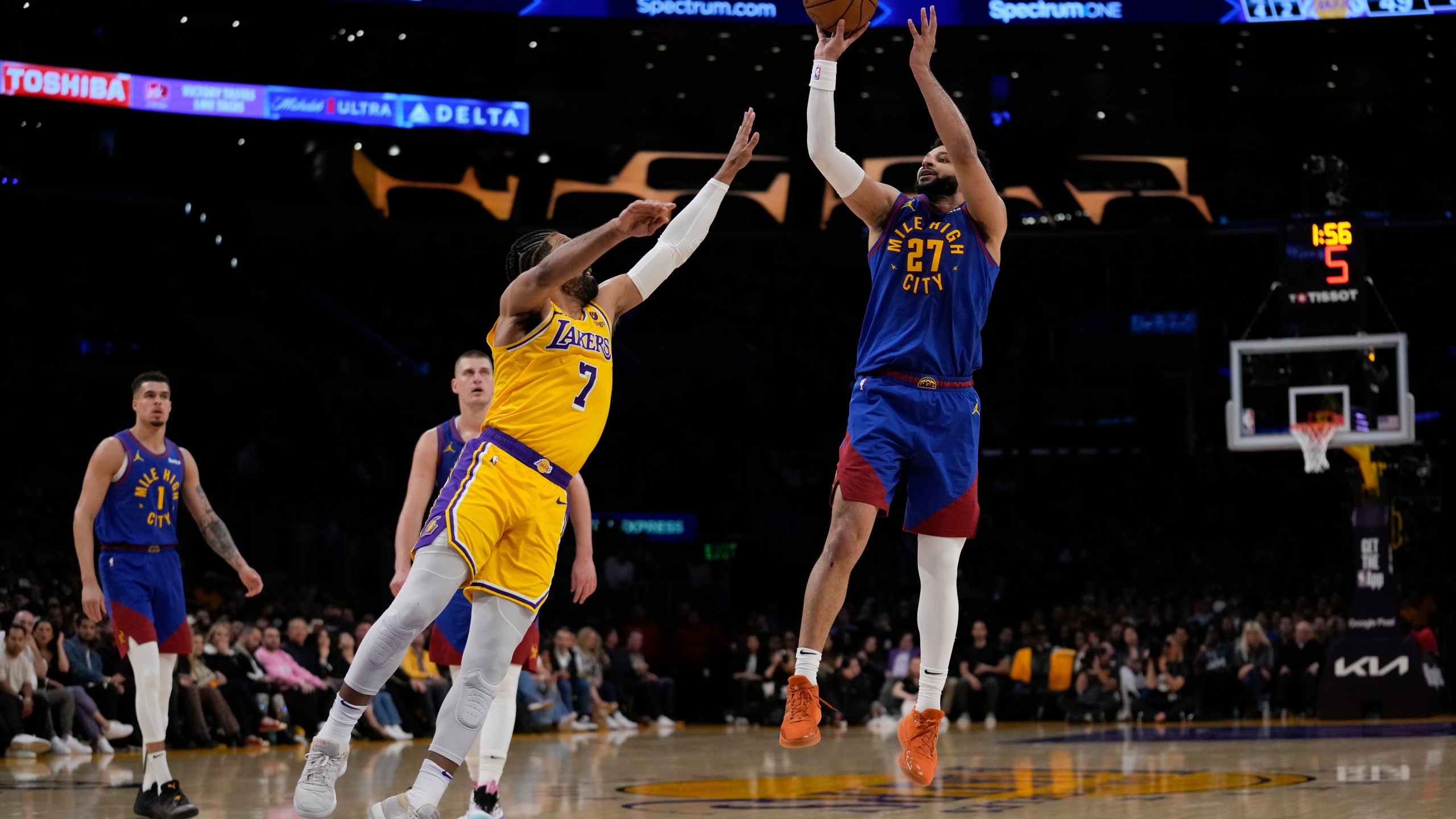 Denver Nuggets guard Jamal Murray (27) shoots against Los Angeles Lakers guard Gabe Vincent (7) during the first half of Game 3 of an NBA basketball first-round playoff series in Los Angeles, Thursday, April 25, 2024. (AP Photo/Ashley Landis)