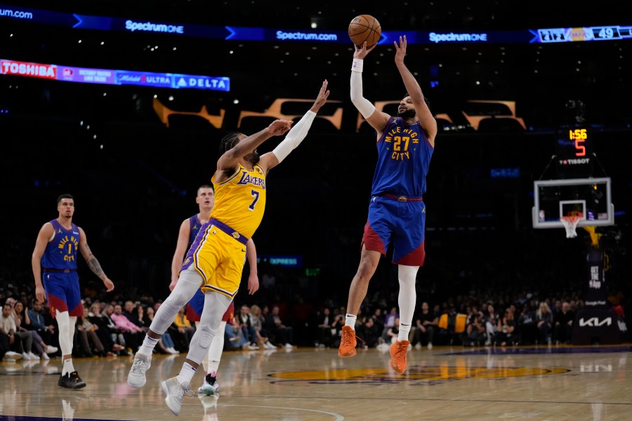 Denver Nuggets guard Jamal Murray (27) shoots against Los Angeles Lakers guard Gabe Vincent (7) during the first half of Game 3 of an NBA basketball first-round playoff series in Los Angeles, Thursday, April 25, 2024. (AP Photo/Ashley Landis)