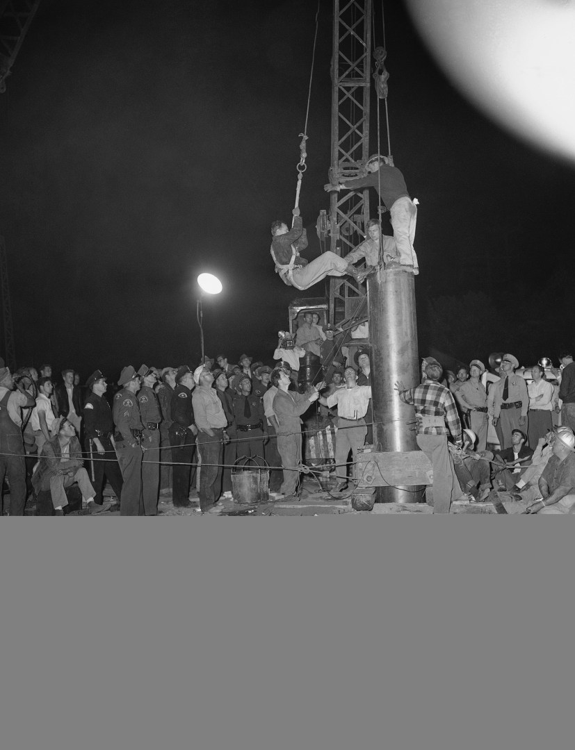 Dr. Robert McCullock clambers up the side of the rescue tube, minutes before he sent up word on April 10, 1949 from below in the abandoned well that Kathy Fiscus was dead. Fiscus, a three year old, was playing with some friends in an open field, when she fell into an open well on April 7, 1949 at San Marino, Cal. For more than 48 hours the disappearance of a small girl tugged at the nation's heartstrings. Little Kathy Fiscus, trapped in the depths of an abandoned well was found dead after unprecedented rescue efforts. Here the doctor is hoisted into the tube for a 95-foot drop to what proved a scene of tragedy . (AP Photo/Harold Filan)