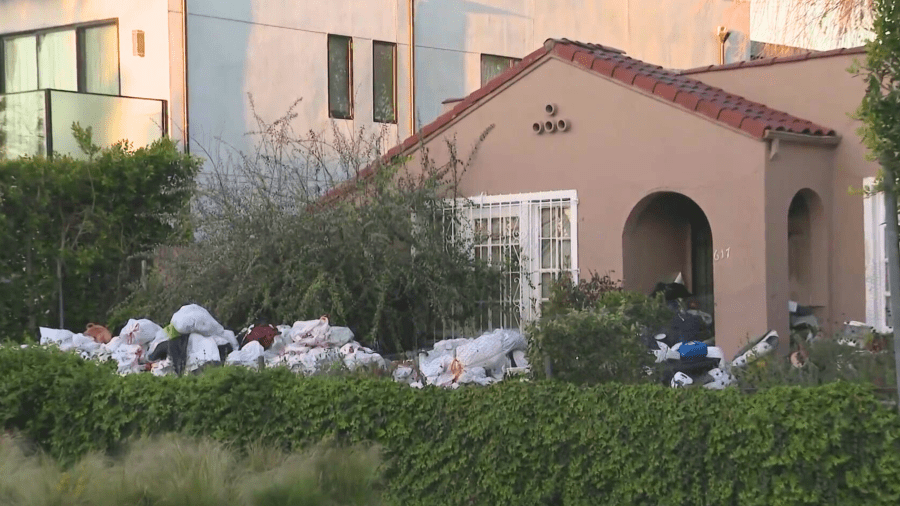 Trash is seen in the front yard of a Fairfax home on April 2, 2024.