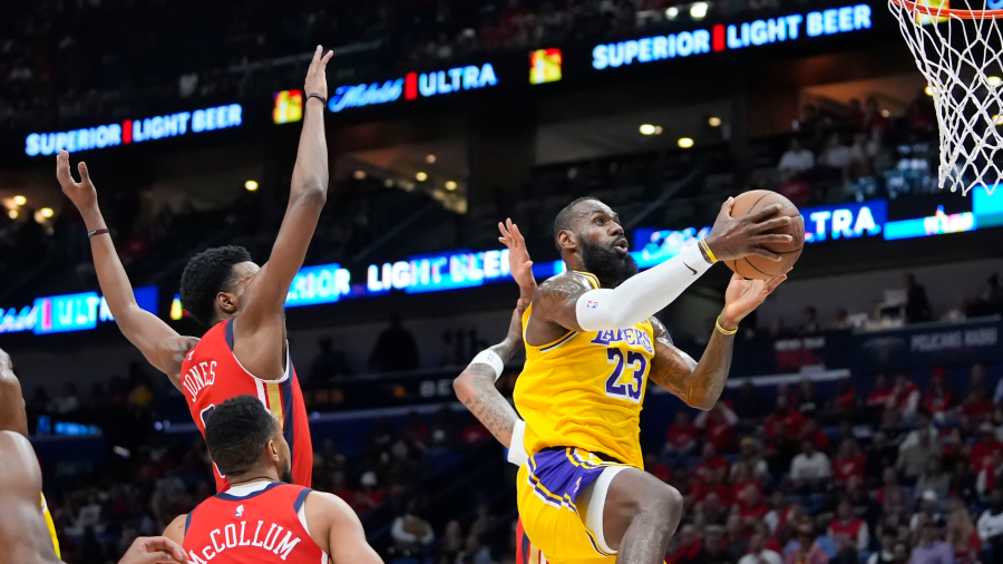 Los Angeles Lakers forward LeBron James goes to the basket in the first half of an NBA basketball play-in tournament game against the New Orleans Pelicans, Tuesday, April 16, 2024, in New Orleans.