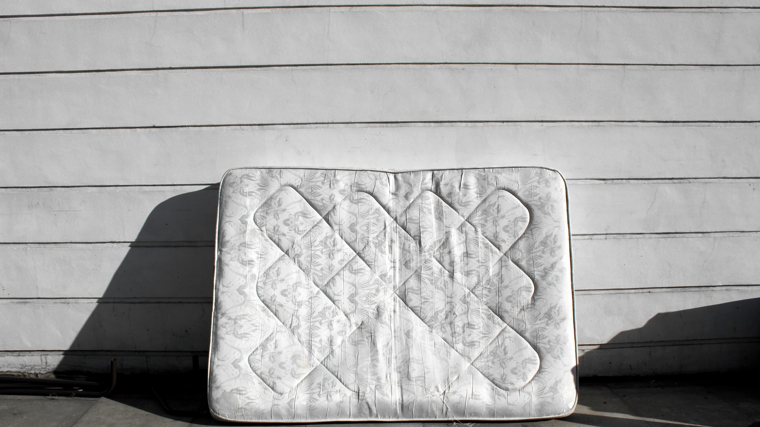 An old mattress leaning up against wall on street is shown in this undated stock image. (Getty Images)