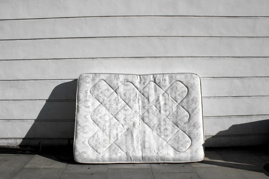 An old mattress leaning up against wall on street is shown in this undated stock image. (Getty Images)