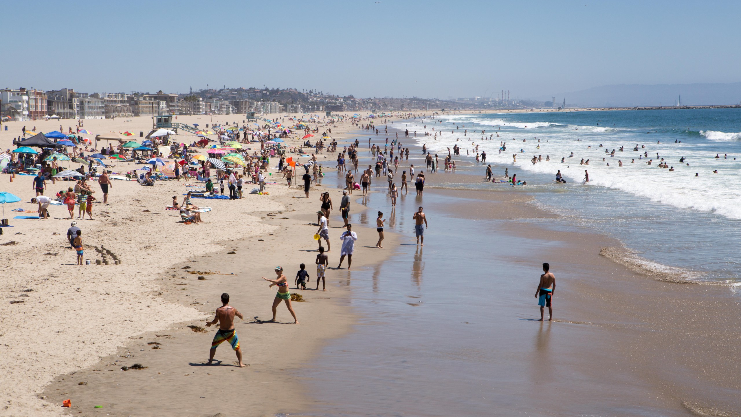 People enjoy sailing, surf, sand, ocean and sunshine at Venice Beach.