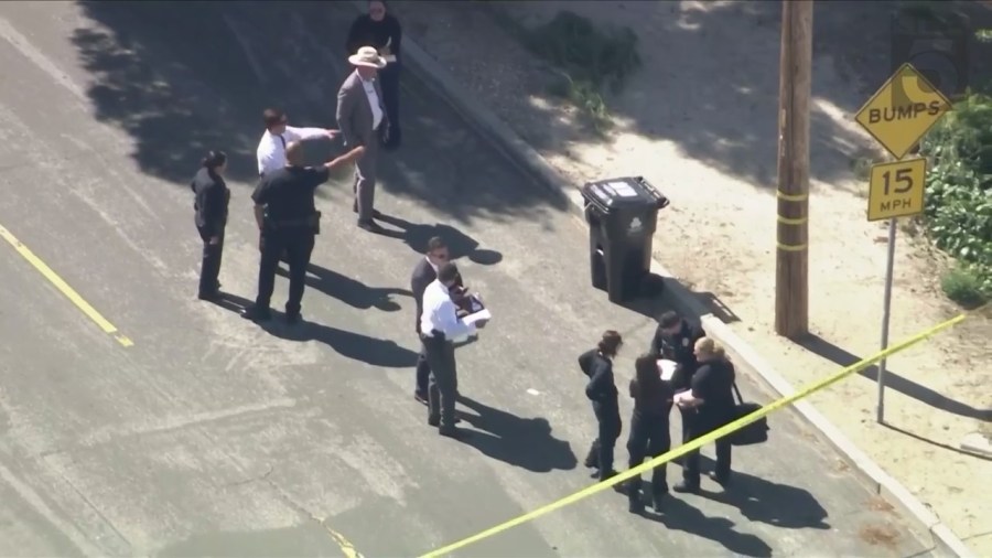 LAPD investigators inspect a trash can where a body was found in Sunland on April 16, 2024. (KTLA)