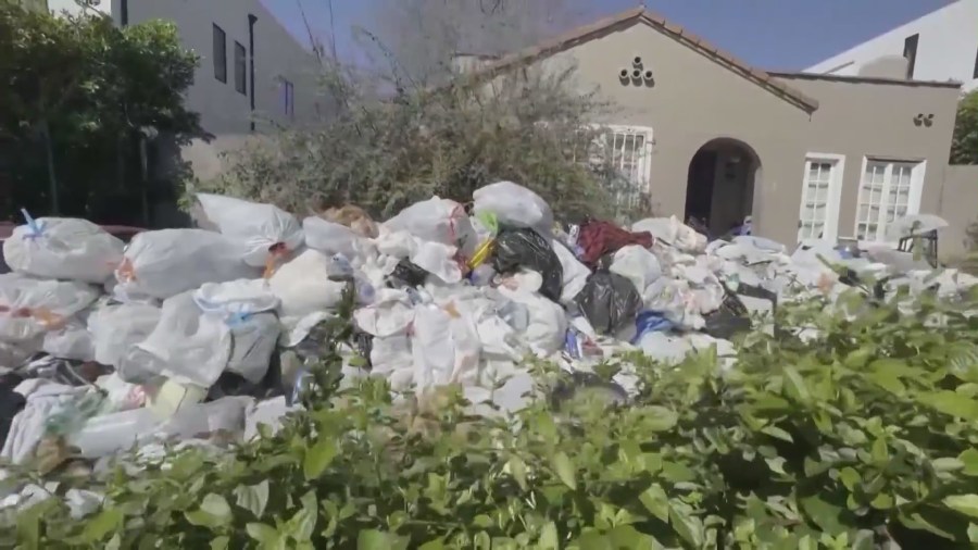 Piles of trash and debris seen in the front yard of a Fairfax home in Los Angeles on April 2, 2024. (KTLA)