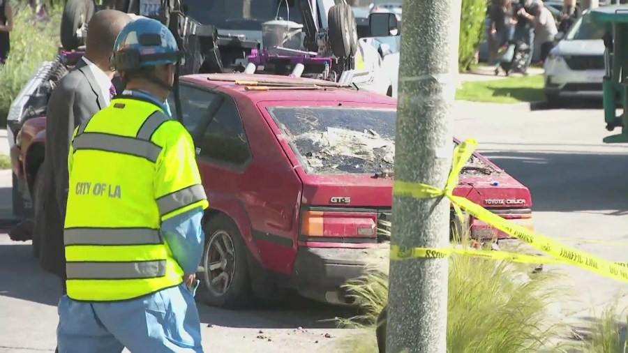 An old Toyota Celica was found underneath a mountain of trash in the front yard of a Fairfax home in Los Angeles on April 3, 2024. (KTLA)