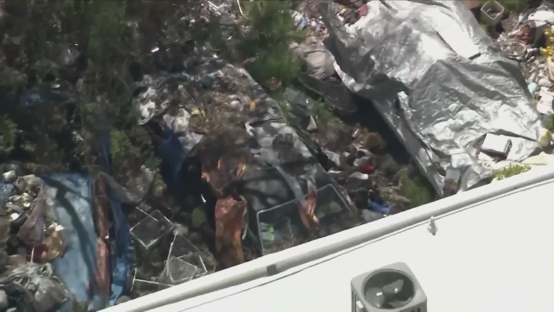 Piles of trash and debris seen in the front and backyard of a Fairfax home in Los Angeles in April 2024. (KTLA)