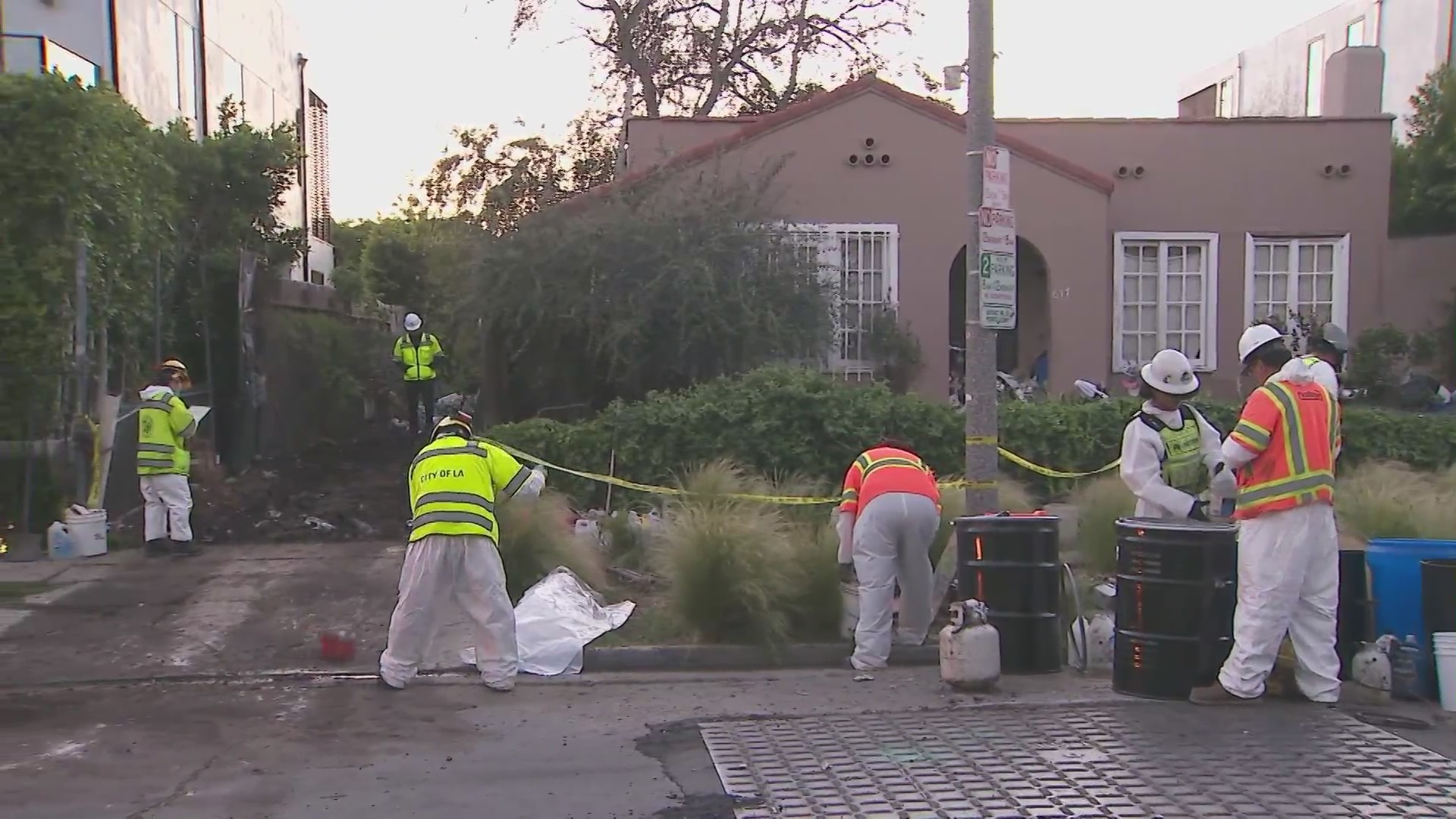 Crews began clearing mountains of trash and debris seen in the front yard of a Fairfax home in Los Angeles on April 3, 2024. (KTLA)