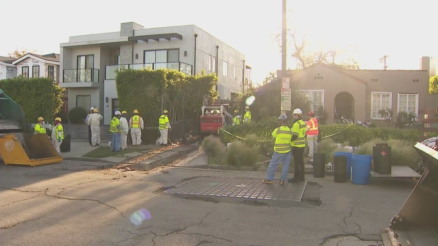 Crews began clearing mountains of trash and debris seen in the front yard of a Fairfax home in Los Angeles on April 3, 2024. (KTLA)