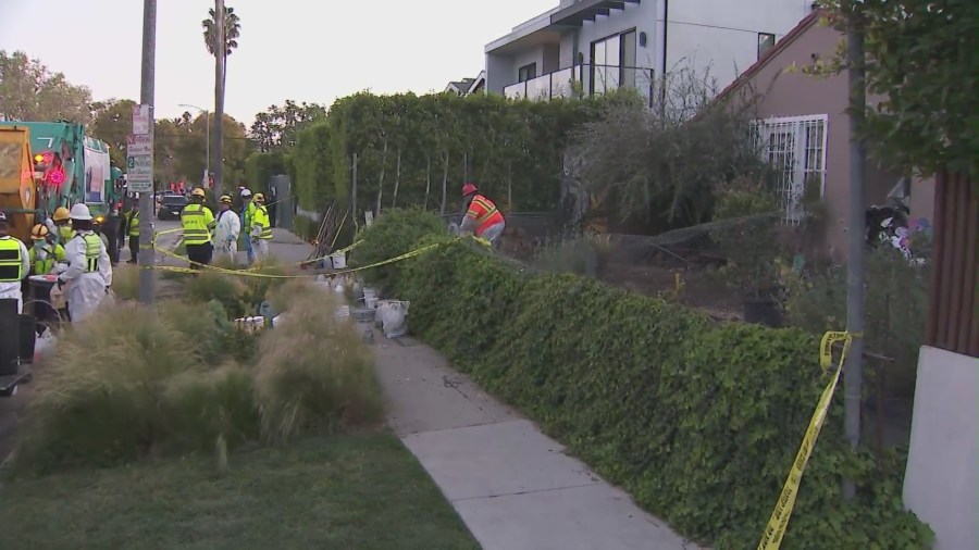 Crews began clearing mountains of trash and debris seen in the front yard of a Fairfax home in Los Angeles on April 3, 2024. (KTLA)